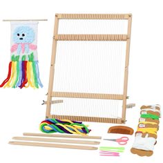 a weaving kit with yarn, scissors and other crafting supplies on a white background