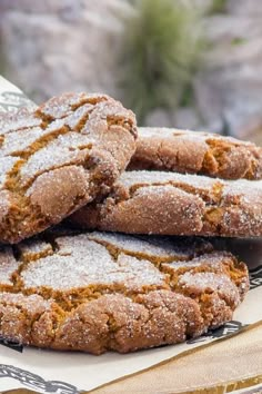 several cookies are stacked on top of each other with powdered sugar and sprinkles