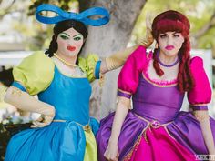 two women dressed in costumes standing next to each other