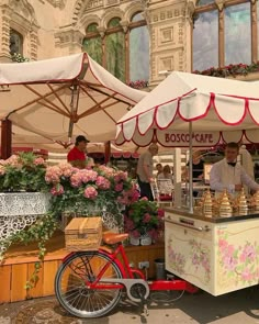 an outdoor food cart with flowers on display