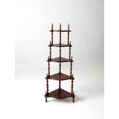 three tiered wooden shelf on white background