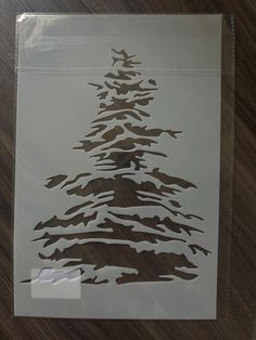 a piece of paper with a christmas tree cut out of it