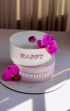 a birthday cake with pink flowers on it