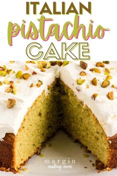 a cake with white frosting and pistachio toppings