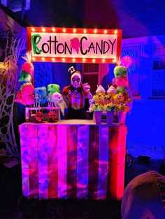 a booth that has some kind of candy on it with lights and decorations around it