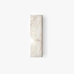 a white wall mounted light fixture with marble finish