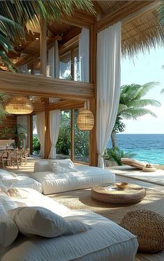 a living room filled with lots of white furniture next to the ocean and palm trees