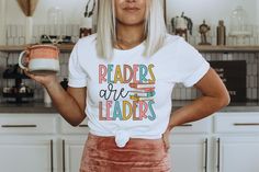 Readers Are Leaders Shirt ♥ HOW TO ORDER ♥ 1) Add the item(s) to your cart and proceed to checkout to complete your order. 2) Choose how you'll pay by selecting your payment method. 3) Enter your shipping information. 4) Select your payment method and review your order. 5) You'll be able to choose your shipping method and add an optional note to us for your item. 6) Select place order. ♥ SIZING AND ITEM DETAILS ♥ Bella+Canvas 3001 Unisex T-Shirt This classic unisex jersey short-sleeve tee fits l White Bookish T-shirt For School, White Bookish Top With Funny Print, Bookish Text Print Tops For School, White Bookish Cotton Top, Cotton Slogan T-shirt, Bookish Cotton Tops For School, White Graphic Print Bookish Tops, White Graphic Print Top, Readers Are Leaders