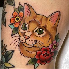 a close up of a cat with flowers on it's leg and the face of a cat