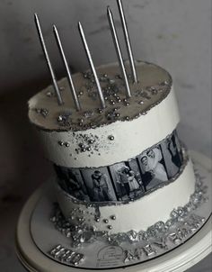 a three tiered cake decorated with photos and silver sparkles on the bottom layer