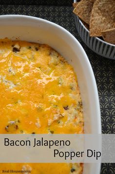 bacon jalapeno popper dip in a casserole dish with tortilla chips