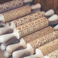 several rolls of wood carved with designs on them