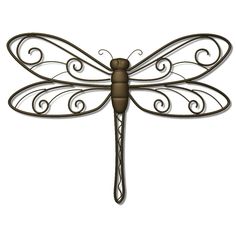 a metal dragonfly sitting on top of a white wall