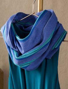 a blue scarf hanging on a clothes rack