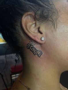 a woman with a tattoo on her ear