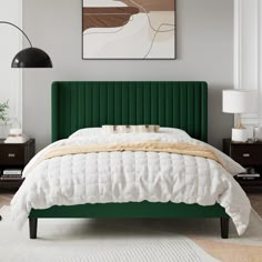 a bedroom with a green headboard and white bedding, two lamps on either side of the bed