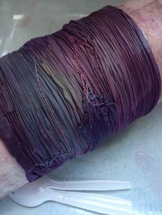 a purple piece of cloth wrapped around plastic forks