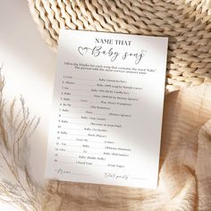 a baby shower game on top of a basket next to a straw hat and paper