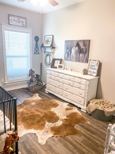 a baby's room with a crib, dresser and bed