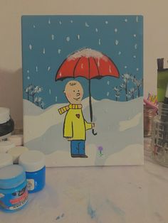 a painting of a man holding an umbrella in the snow with other paint supplies nearby