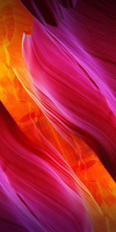 an abstract image of red, orange and purple colors in the desert with long wavy lines