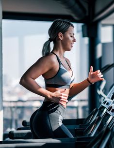 a woman is running on a treadmill