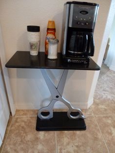 a coffee maker sitting on top of a black shelf