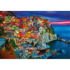 an image of a colorful village on the edge of a body of water at night