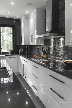 a black and white kitchen with marble counter tops