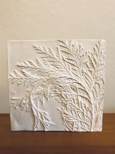 a white sculpture sitting on top of a wooden table