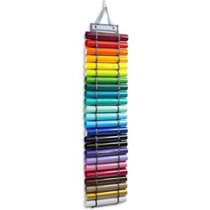 a rack with many different colored crayons hanging from it's sides,