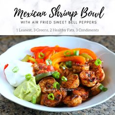 the mexican shrimp bowl with avocado, peppers and sour cream is ready to be eaten