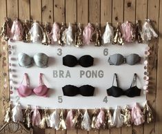 a sign with bra pong on it in front of a wooden wall and several other bras