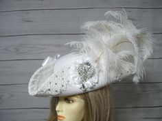 "Beautiful made to order white woolen wedding pirate hat with handsewn white Venise lace around the brim with hand placed glass rhinestones that sparkly in the light, two white satin bows, white satin cocarde with a large sparkly jewel and a waterfall of white ostrich feathers. This hat is so pretty and was a labor of love. Perfect for a pirate themed wedding. The brim of the hat is 4\" folded up. This is not an oversized pirate hat. This hat is 22.5\" for the inside circumference. This hat has a built-in hat adjuster, just cinch and tie for a tighter fit. I cannot make the circumference bigger so please keep that in mind. Please measure your head before ordering as I do not take returns as all sales are final. Check out my other pirate hats and other goodies in my etsy shop. Thank you for Handmade White Wedding Hat, Handmade White Wedding Costume Hats And Headpieces, White Handmade Wedding Costume Hats And Headpieces, Handmade White Mini Hats For Wedding, Handmade White Wedding Headpieces, Steampunk Pirate Female, Musketeer Costume, Sea Fashion