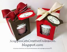 two small boxes with red and white cups in them, one has a bow on the top