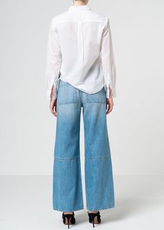 These voluminous yet supple wide leg jeans boast an artfully spliced silhouette and a medium light blue wash in a rigid soft denim fabric for a luxurious look. Model is 5'10" wearing size 26. Approx. Front rise: 11.5" Inseam: 30.5"Approx. Knee: 23.25" Leg opening: 22.5" 100% CottonMade in USA Fits true to size. Baggy Shorts, Jumpsuit Jacket, Kick Flares, Independent Designers Fashion, Denim Top, Denim Fabric, Wide Leg Jeans, Leg Jeans, Top Styles