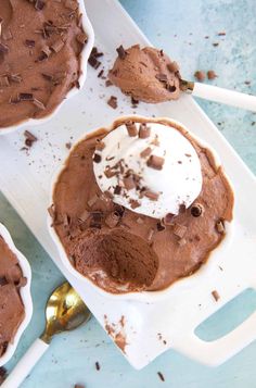 chocolate dessert with whipped cream on top and spoons