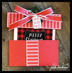 a red and black christmas card with a bow