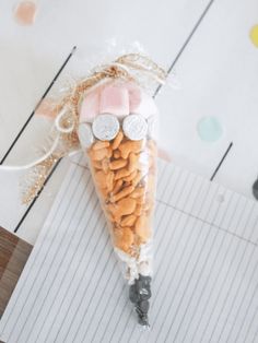 a candy cone filled with candies on top of a piece of paper