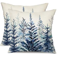 two blue and white pillows with trees on them