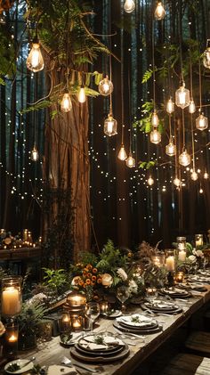 a long table is set with candles, plates and place settings for an outdoor dinner