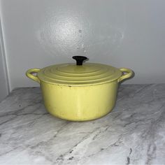 a yellow casserole sitting on top of a white counter next to a wall