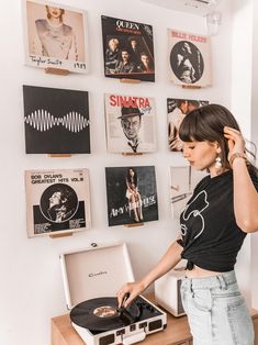 a woman standing in front of a record player