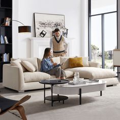 a man and woman sitting on a couch in a living room next to each other