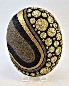 an egg with gold and black designs on it