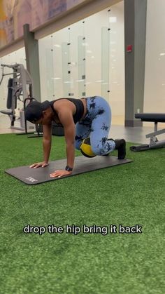 a woman doing push ups on a mat in a gym with the words drop the hip bring it back