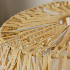 a close up of a chair made out of wooden sticks and plywood strips,