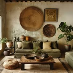 a living room filled with lots of furniture next to a wall mounted planter and potted plants