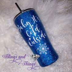 a blue glitter tumbler with snowflakes on it