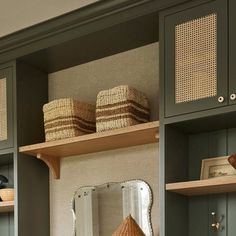 a room with some shelves and baskets on top of them, along with other items